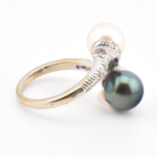 77 - An 18ct gold, cultured pearl and diamond crossover ring. The ring having two cultured pearls set in ... 