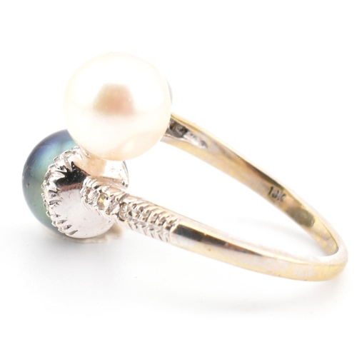 77 - An 18ct gold, cultured pearl and diamond crossover ring. The ring having two cultured pearls set in ... 