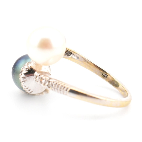 77 - An 18ct gold, cultured pearl and diamond crossover ring. The ring having two cultured pearls set in ... 