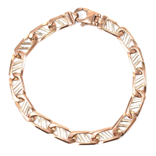 79 - A hallmarked 9ct gold two-tone fancy link chain bracelet. The bracelet having 9ct rose and white gol... 