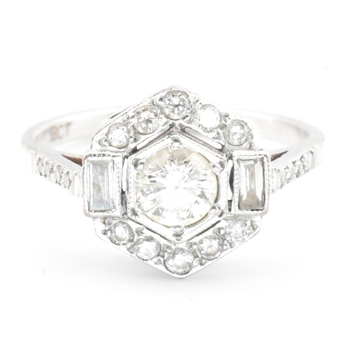 80 - An 18ct white gold and diamond Art Deco ring. The ring set with a central round cut diamond flanked ... 