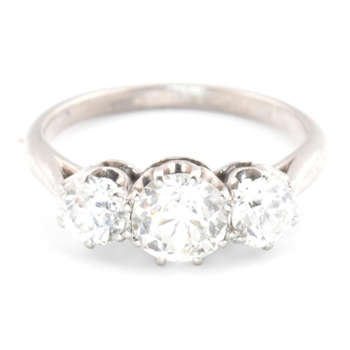 83 - A platinum and diamond trilogy ring. The ring having three graduating round cut diamonds to tapered ... 