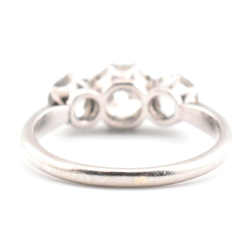 83 - A platinum and diamond trilogy ring. The ring having three graduating round cut diamonds to tapered ... 