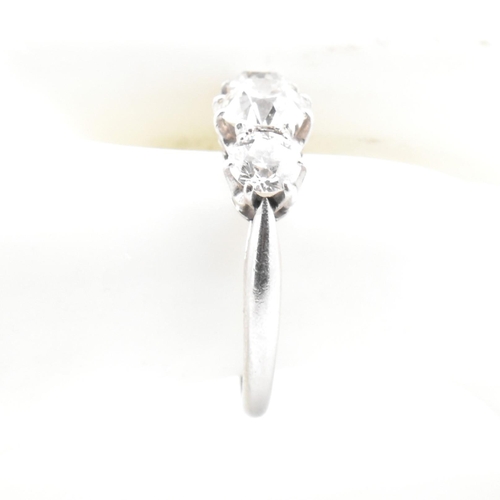 83 - A platinum and diamond trilogy ring. The ring having three graduating round cut diamonds to tapered ... 