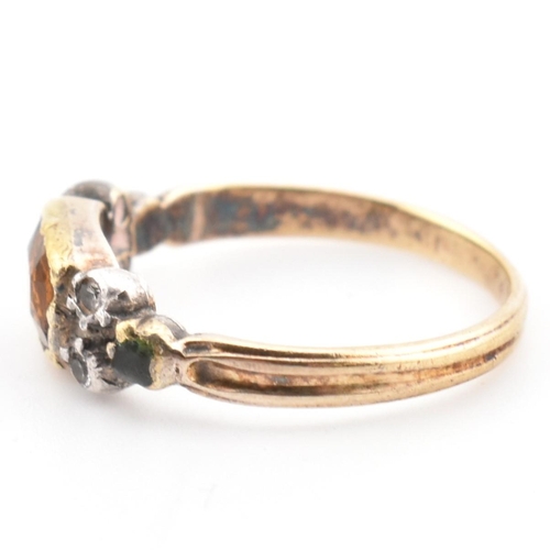 85 - A 19th century gold and silver gem set ring. The ring set with a bezel set citrine flanked by diamon... 