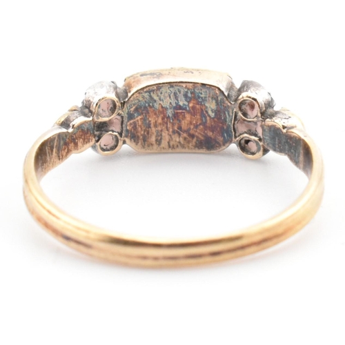 85 - A 19th century gold and silver gem set ring. The ring set with a bezel set citrine flanked by diamon... 