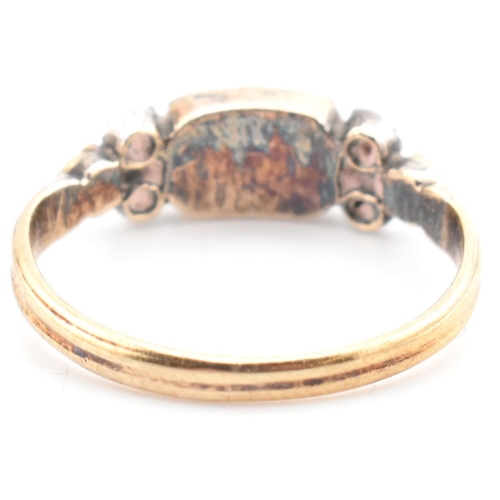 85 - A 19th century gold and silver gem set ring. The ring set with a bezel set citrine flanked by diamon... 