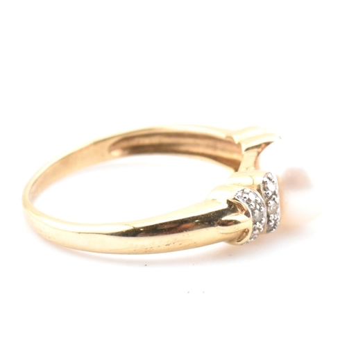 87 - A hallmarked 9ct gold, diamond and cultured pearl ring. The 9ct yellow gold ring having a single rou... 