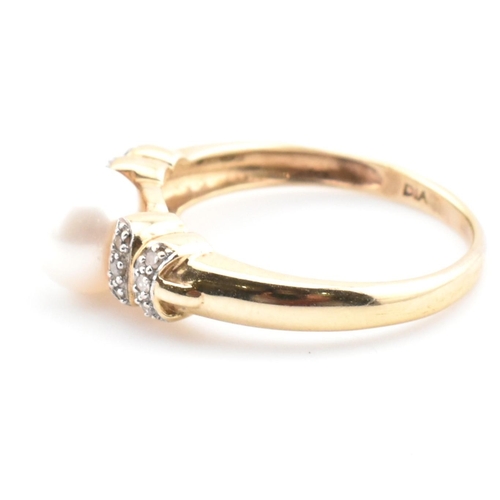 87 - A hallmarked 9ct gold, diamond and cultured pearl ring. The 9ct yellow gold ring having a single rou... 