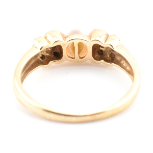 87 - A hallmarked 9ct gold, diamond and cultured pearl ring. The 9ct yellow gold ring having a single rou... 