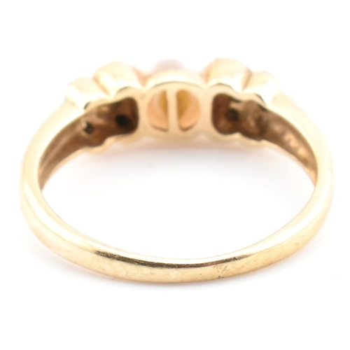 87 - A hallmarked 9ct gold, diamond and cultured pearl ring. The 9ct yellow gold ring having a single rou... 