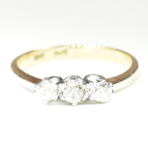 88 - An 18ct gold, platinum and diamond trilogy ring. The ring having three shared claw set round cut dia... 