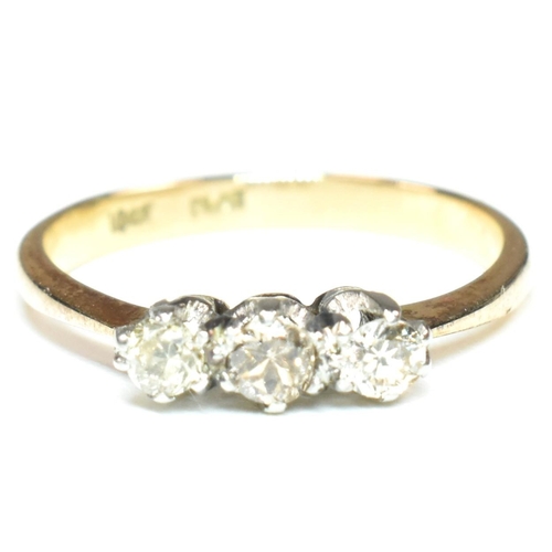 88 - An 18ct gold, platinum and diamond trilogy ring. The ring having three shared claw set round cut dia... 