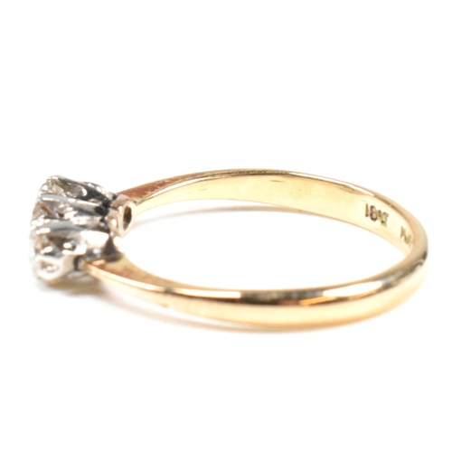 88 - An 18ct gold, platinum and diamond trilogy ring. The ring having three shared claw set round cut dia... 