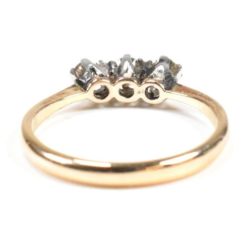 88 - An 18ct gold, platinum and diamond trilogy ring. The ring having three shared claw set round cut dia... 