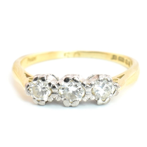 91 - A hallmarked 18ct gold and diamond trilogy ring. The 18ct yellow gold ring having three graduating d... 