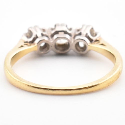 91 - A hallmarked 18ct gold and diamond trilogy ring. The 18ct yellow gold ring having three graduating d... 