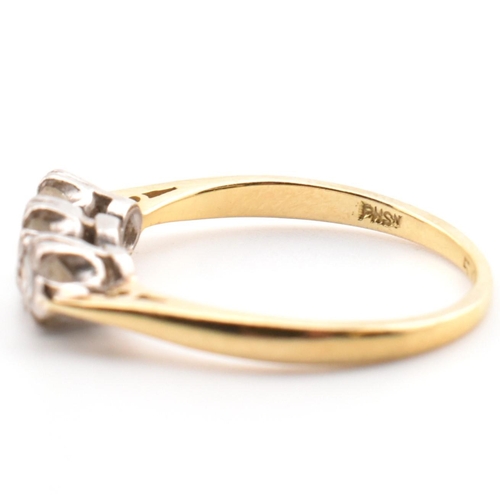 91 - A hallmarked 18ct gold and diamond trilogy ring. The 18ct yellow gold ring having three graduating d... 