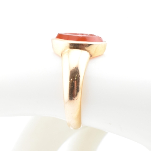 93 - A gold and carnelian intaglio signet ring. The signet ring set with a carnelian intaglio seal depict... 