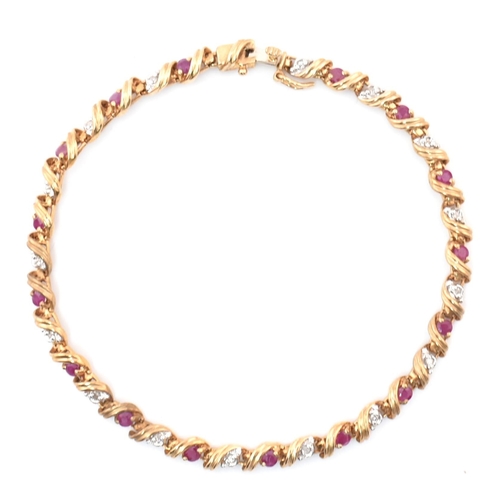 94 - A hallmarked 9ct gold, diamond and ruby line bracelet. The 9ct yellow gold bracelet having round cut... 