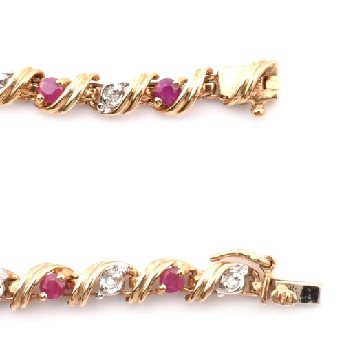 94 - A hallmarked 9ct gold, diamond and ruby line bracelet. The 9ct yellow gold bracelet having round cut... 