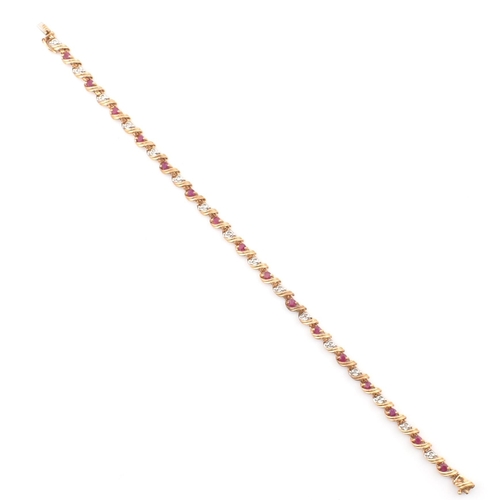 94 - A hallmarked 9ct gold, diamond and ruby line bracelet. The 9ct yellow gold bracelet having round cut... 