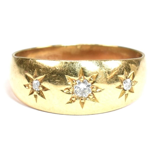 97 - A hallmarked 18ct gold and diamond gypsy ring. The antique ring having three star set old cut diamon... 