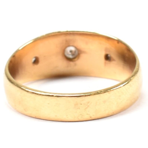 97 - A hallmarked 18ct gold and diamond gypsy ring. The antique ring having three star set old cut diamon... 