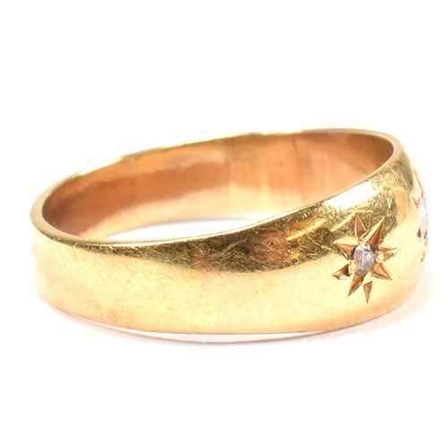 97 - A hallmarked 18ct gold and diamond gypsy ring. The antique ring having three star set old cut diamon... 