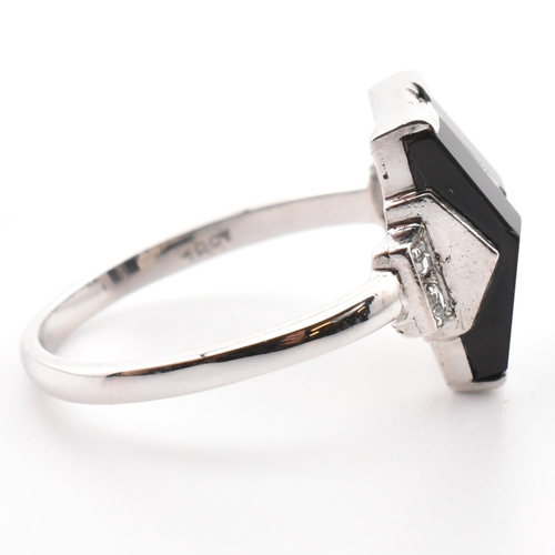 38a - An 18ct white gold Art Deco onyx and diamond ring. The ring set with a central column of six rose cu... 