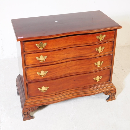 1011 - A George II revival mahogany serpentine front bachelors chest of drawers. The chest raised on carved... 