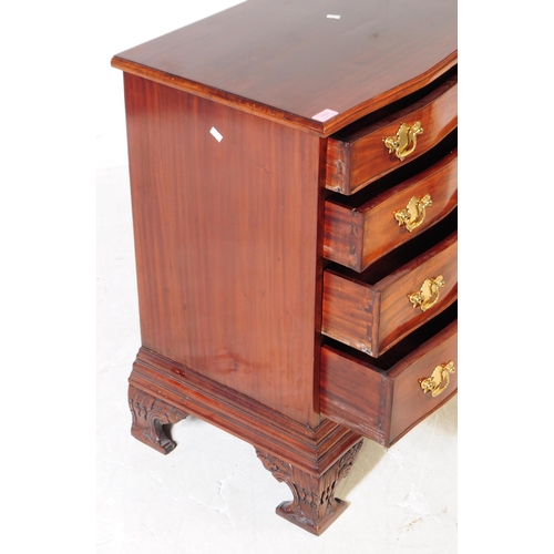 1011 - A George II revival mahogany serpentine front bachelors chest of drawers. The chest raised on carved... 