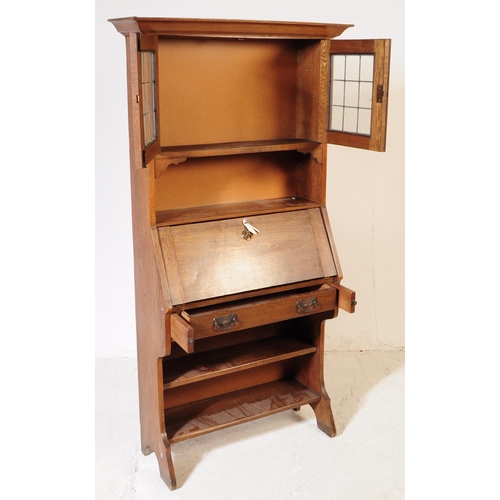 1012 - An early 20th century Arts and Crafts oak student bookcase bureau. The bureau having bookcase shelve... 