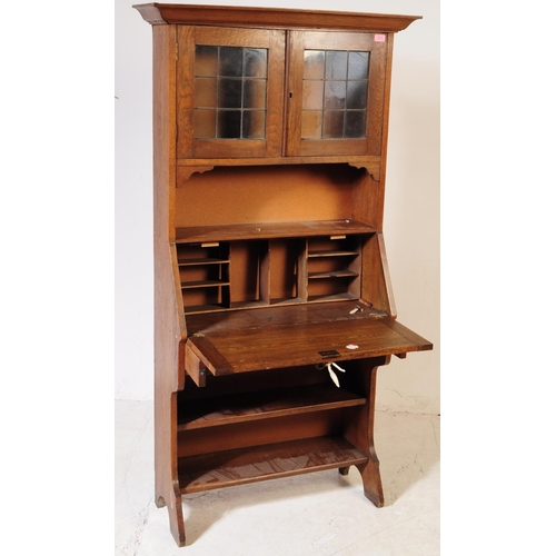 1012 - An early 20th century Arts and Crafts oak student bookcase bureau. The bureau having bookcase shelve... 