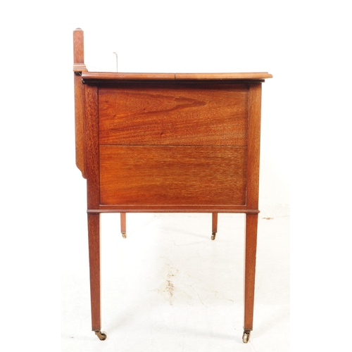 1016 - An early 20th century Edwardian mahogany writing table desk. The writing table raised on tapered squ... 