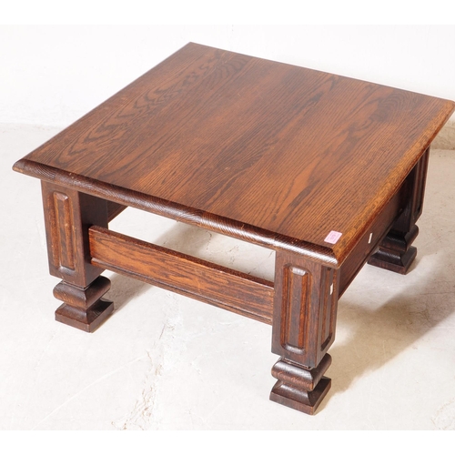 1019 - Banks of Bristol - A pair of 20th century oak wood coffee tables. The tables each raised on four squ... 