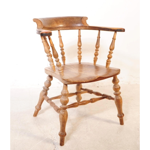 1021 - A 19th century Victorian beech and elm wood smokers bow armchair. The chair having a saddle seat rai... 