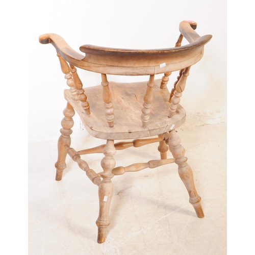 1021 - A 19th century Victorian beech and elm wood smokers bow armchair. The chair having a saddle seat rai... 