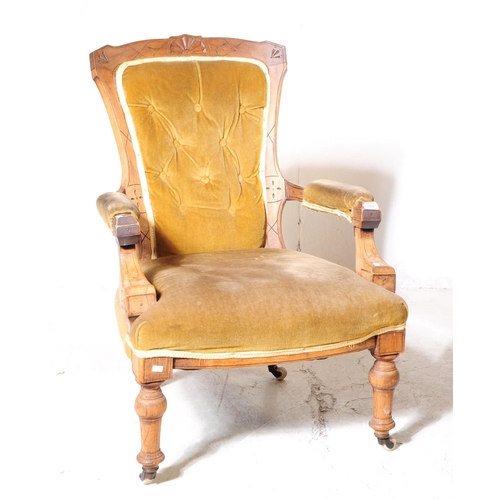 1022 - A 19th century Victorian oak framed gentleman's library armchair. The chair with button back green u... 