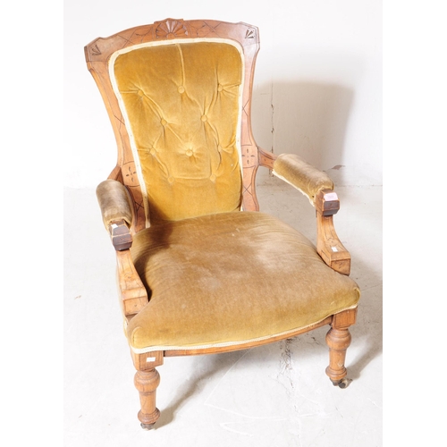 1022 - A 19th century Victorian oak framed gentleman's library armchair. The chair with button back green u... 