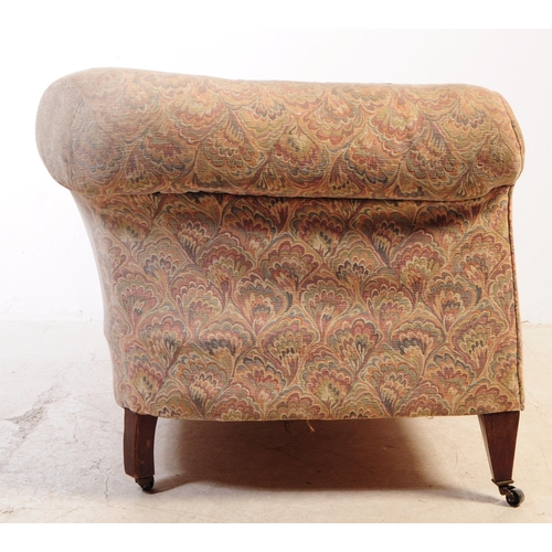 1023 - An early 20th century Edwardian chesterfield sofa and tub armchair. The sofa upholstered in polychro... 