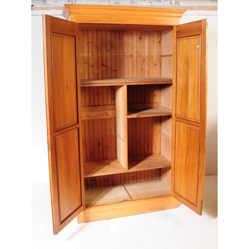 1025 - An early 20th century Edwardian walnut school cupboard. The school cupboard raised on a plinth base,... 