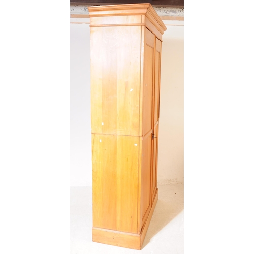 1025 - An early 20th century Edwardian walnut school cupboard. The school cupboard raised on a plinth base,... 