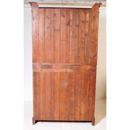 1025 - An early 20th century Edwardian walnut school cupboard. The school cupboard raised on a plinth base,... 