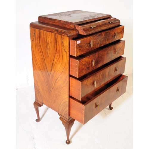 1028 - A 1930s Art Deco walnut chest of drawers. The chest having a series of five drawers, each with bar h... 