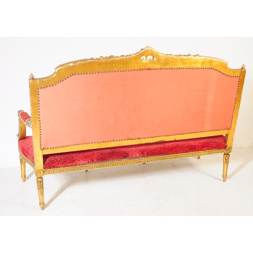 1029 - A 19th century Louis XV French giltwood three seater canape salon sofa settee. The canape having orn... 