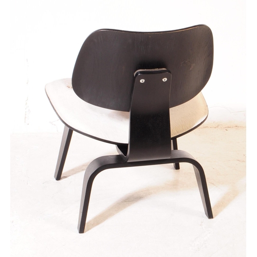 613 - Vitra Eames - A vintage Vitra Eames plywood and calf skin chair. The chair having back and seat upho... 