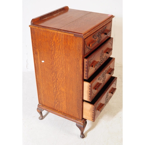 1040 - An early 20th Century circa 1930s arts and crafts oak four drawer chest of drawers having hand carve... 