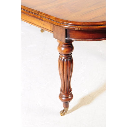 1044 - A Victorian revival mahogany wind out dining table. The table raised on shaped gadrooned supports ov... 