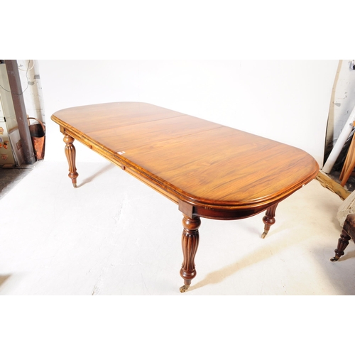 1044 - A Victorian revival mahogany wind out dining table. The table raised on shaped gadrooned supports ov... 